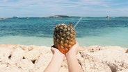 woman holding pineapple